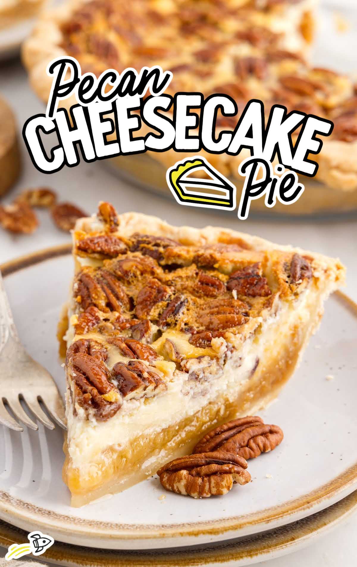 a slice of Pecan Cheesecake Pie on a plate with a fork