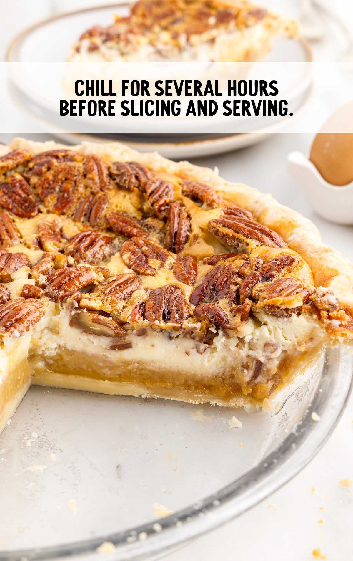 Pecan Cheesecake Pie in a baking dish with a slice removed