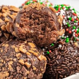 close up shot of Rum Balls stacked on top of each other on a plate