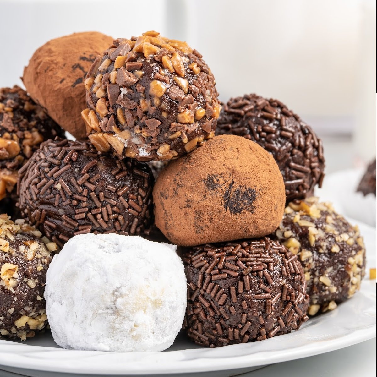 close up shot of Rum Balls stacked on top of each other on a plate