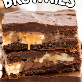 a close up shot of Snickers Brownies stacked on top of each other