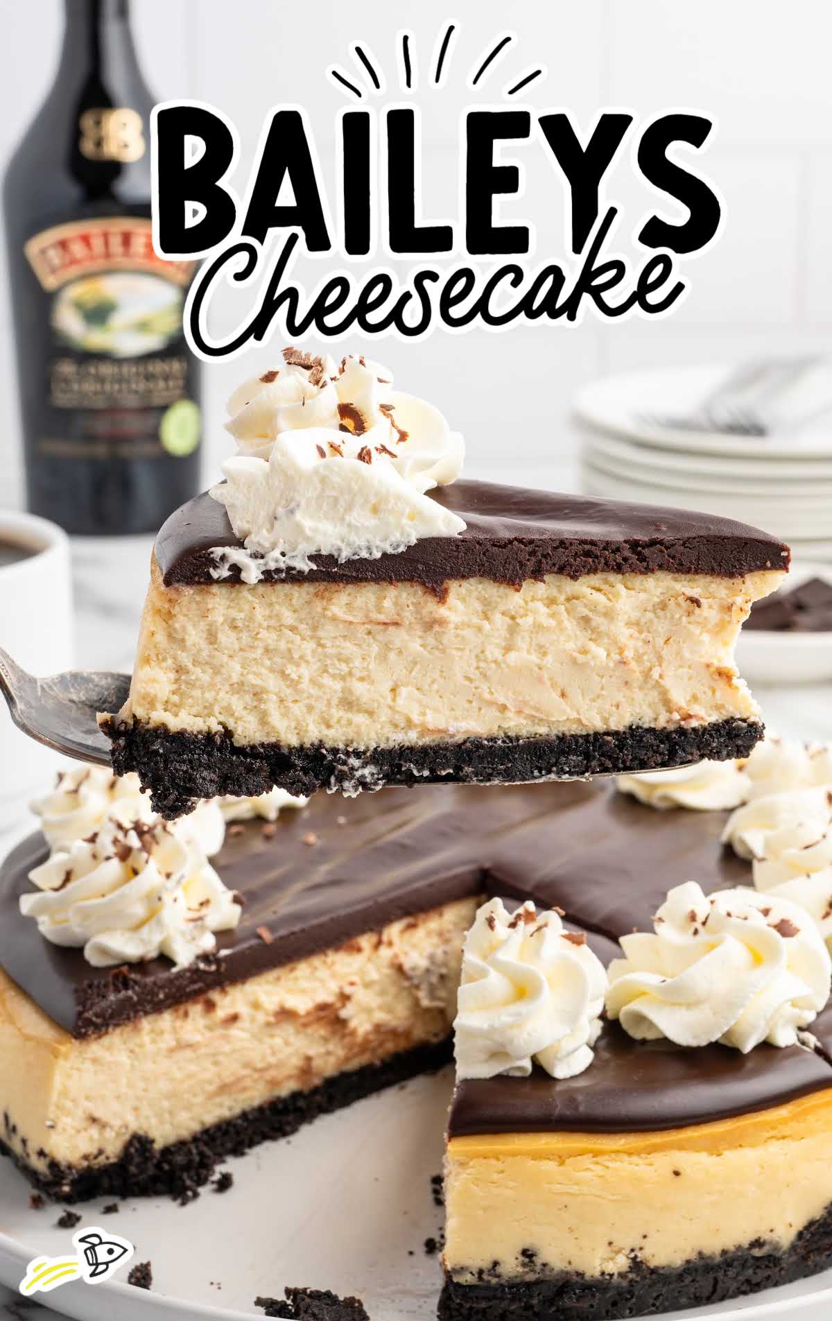 Whole Baileys Irish Cream cheesecake with glossy ganache topping and piped whipped cream around the edges.