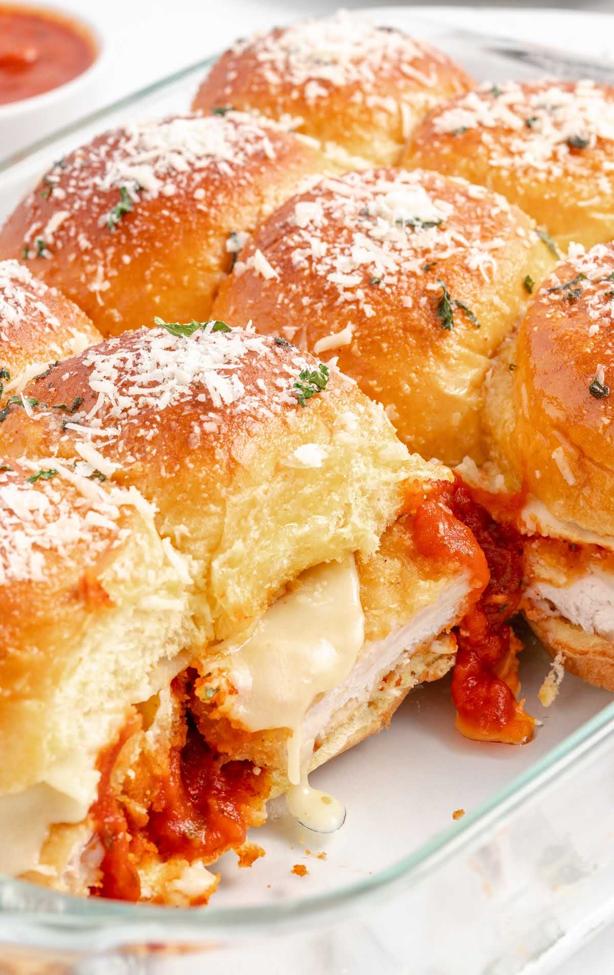 close up shot of a Chicken Parmesan Sliders in a baking dish