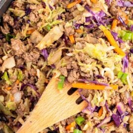 overhead shot of Crack Slaw in a skillet with a wooden spoon