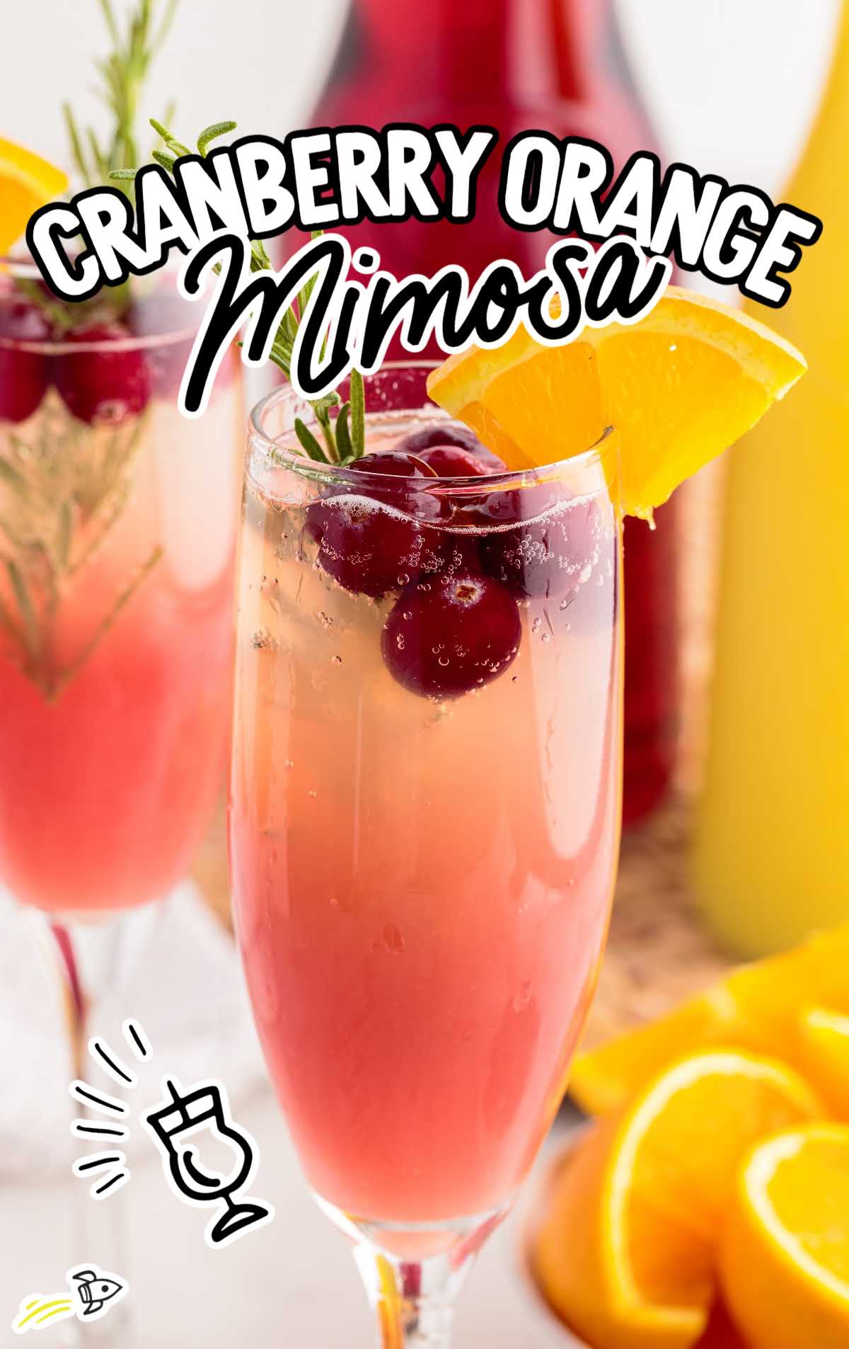 a glass of Cranberry Orange Mimosa garnished with a slice of orange and cranberries