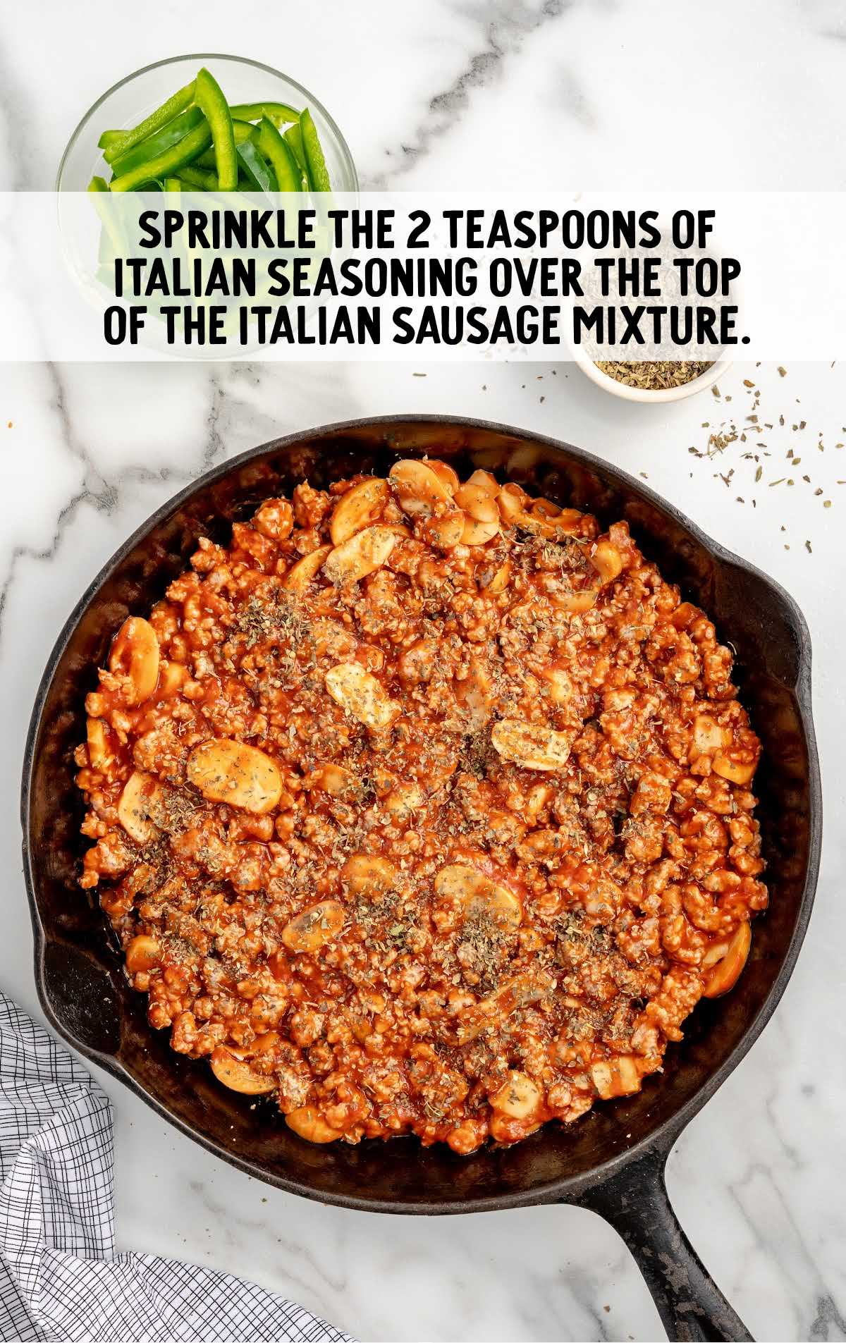 Italian seasonings sprinkled over the Italian sausage mixture in a skillet