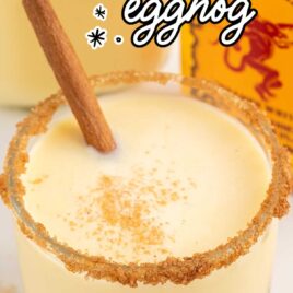 a glass of Fireball Eggnog sprinkled with cinnamon and garnished with a cinnamon stick
