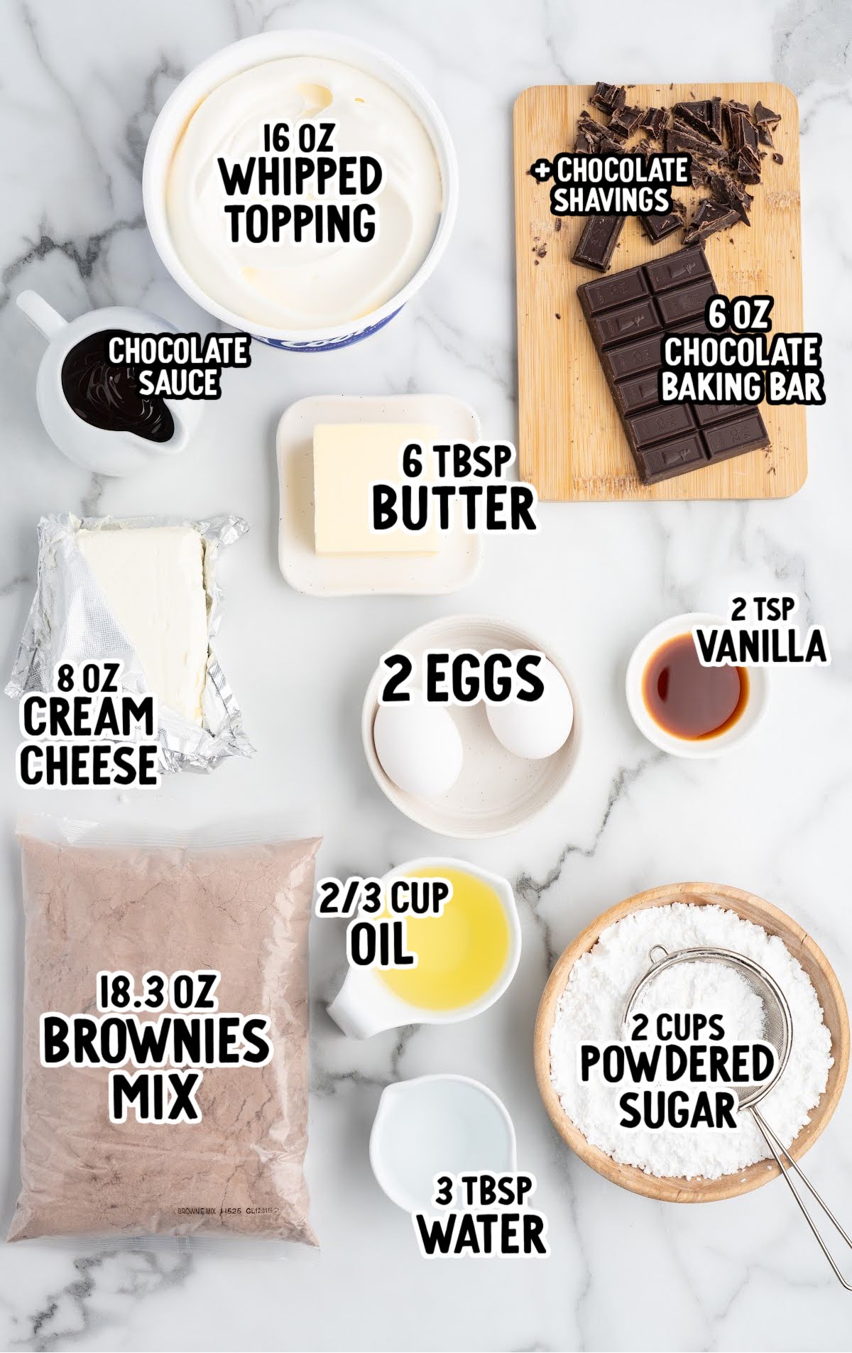 Flat-lay of all ingredients needed for French silk brownies: brownie mix, eggs, water, oil, butter, cream cheese, powdered sugar, whipped topping, vanilla, chocolate baking bar, and chocolate sauce arranged neatly on a marble surface with labels.