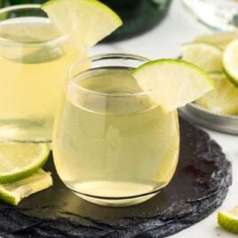a close up shot of Green Tea Shot in a glass cup garnished with a slice of lime