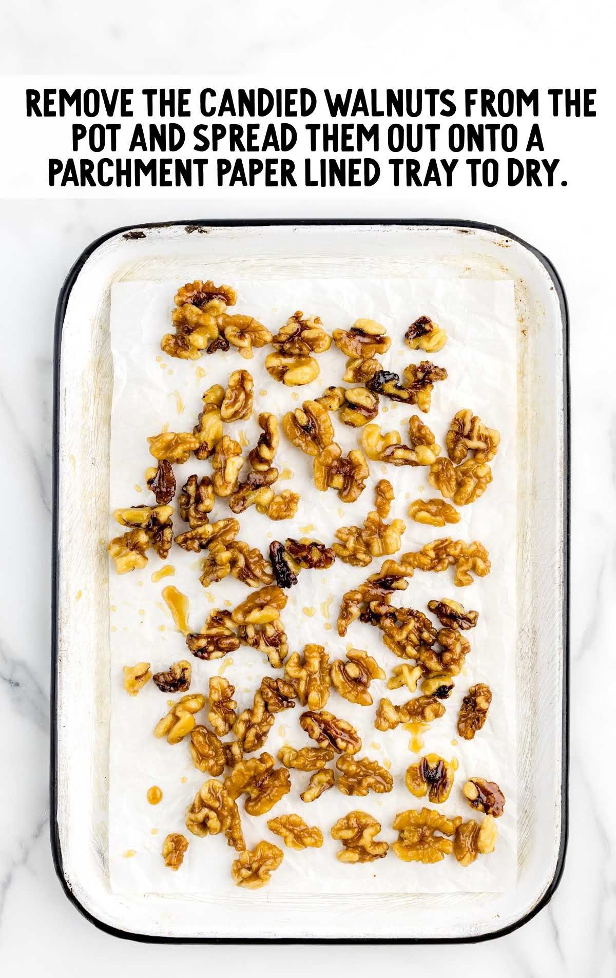 candied walnuts placed on a parchment lined tray