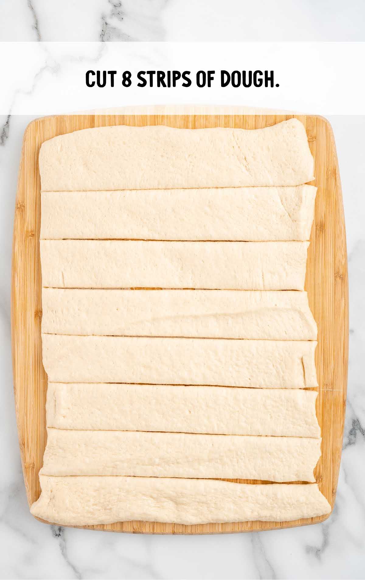 strips of dough cut on a wooden board