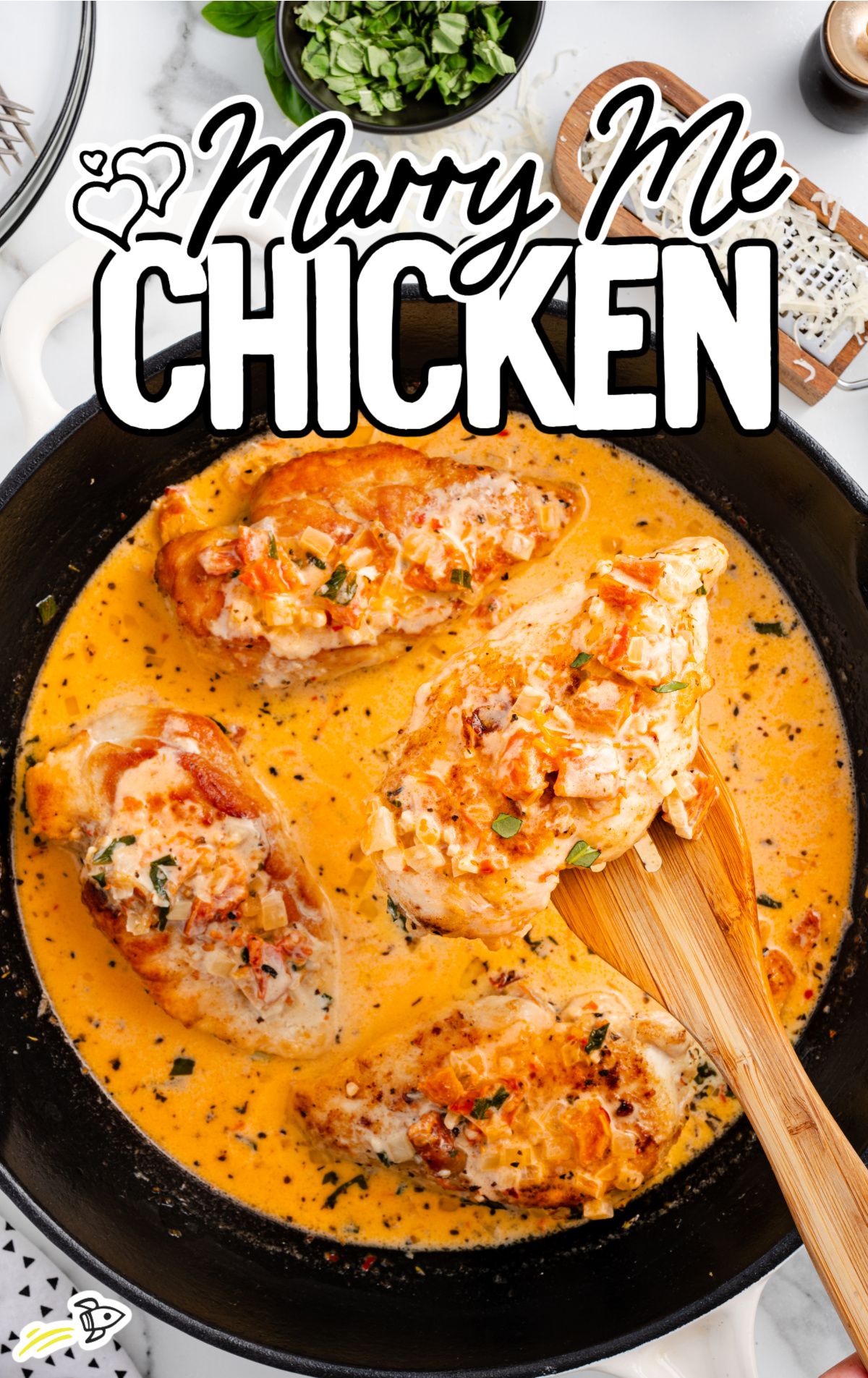 A cast iron skillet full of chicken and sauce.