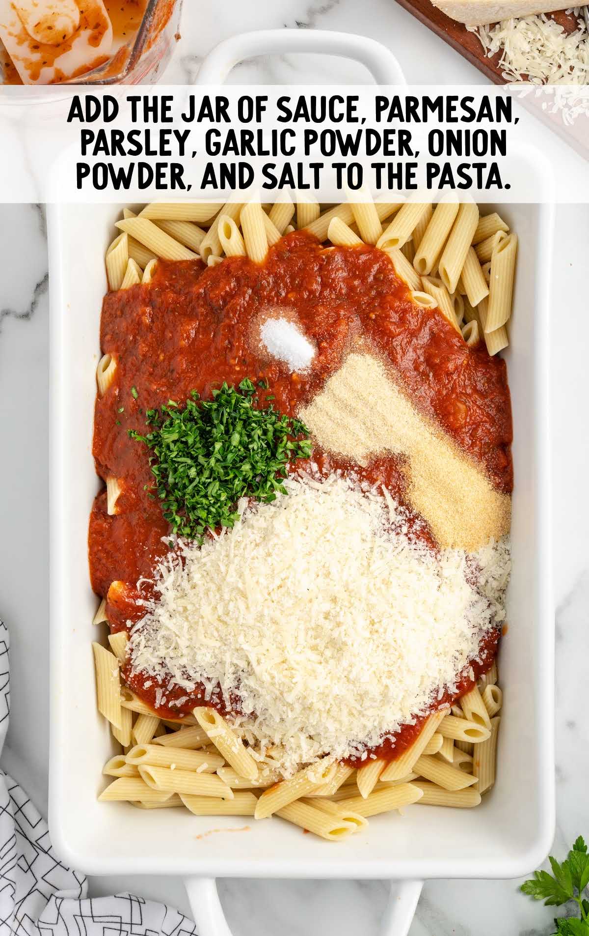 jar of sauce, parmesan, parsley, garlic powder, onion powder, and salt added to the pasta