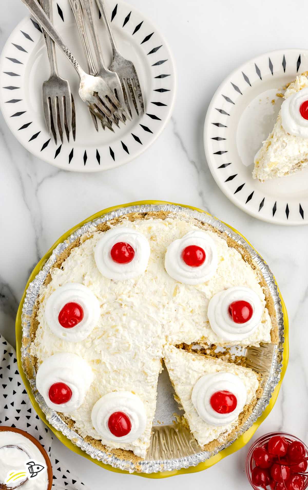 slices of Pineapple Pie topped with whipped cream and a cherries