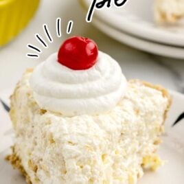 a slice of Pineapple Pie topped with whipped cream and a cherry on a plate