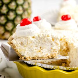 slices of Pineapple Pie topped with whipped cream and cherries
