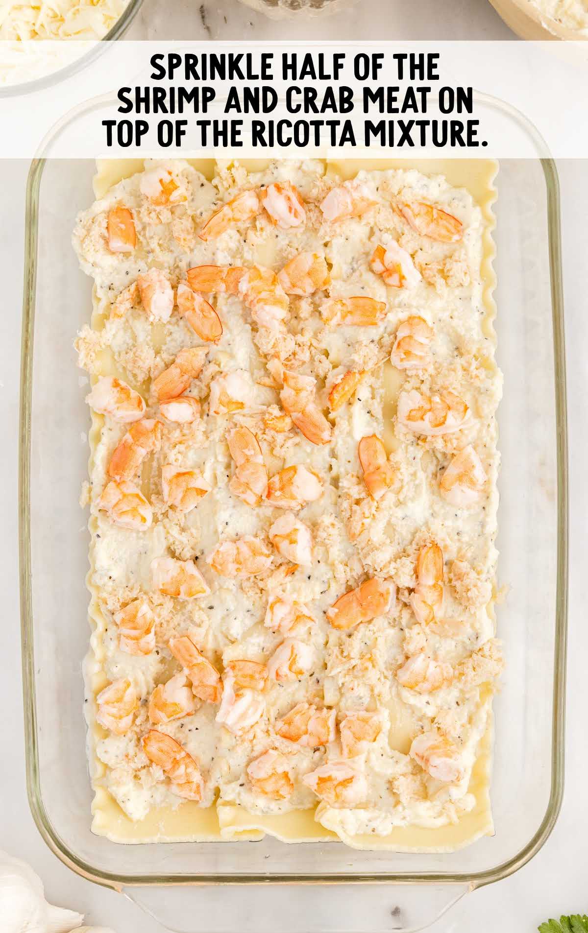 shrimp and crabs sprinkled on top of the ricotta mixture