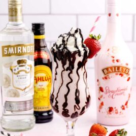 close up shot of a Strawberry Mudslide topped with chocolate sauce, whipped cream, and a strawberry