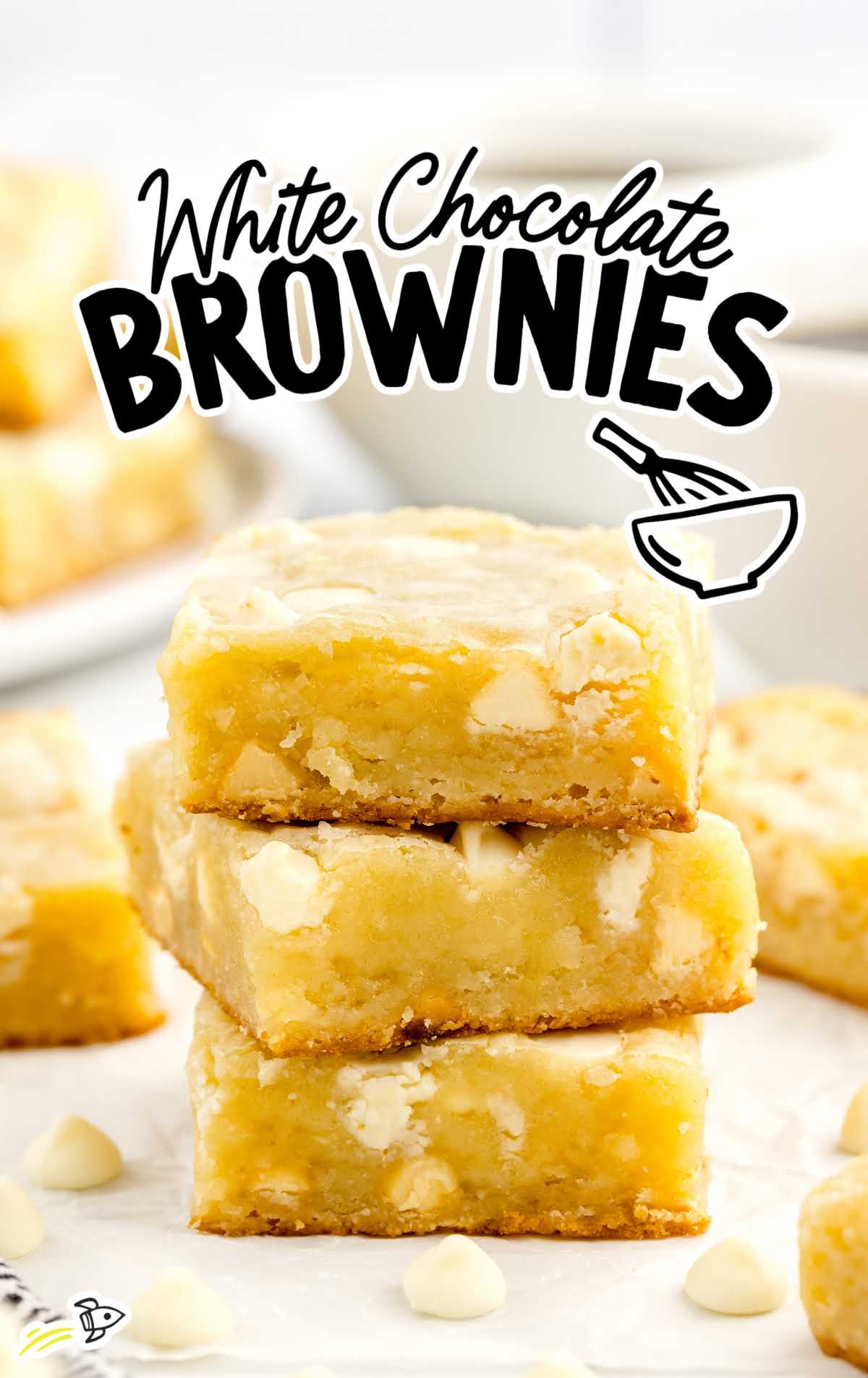 a close up shot of White Chocolate Brownies stacked on top of each other