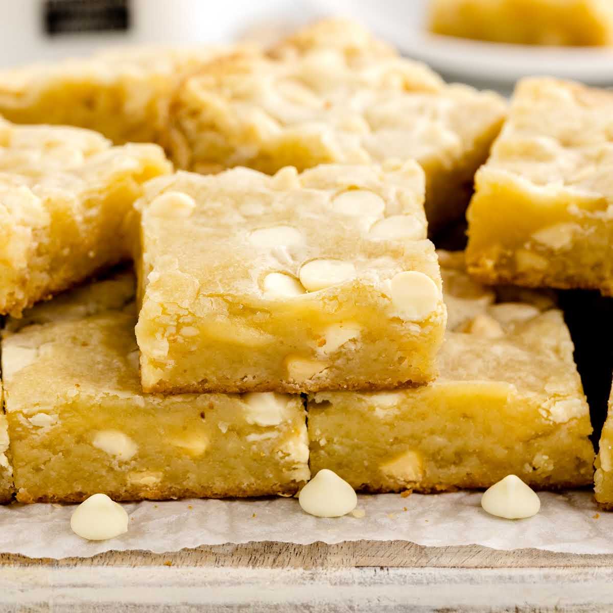 a close up shot of White Chocolate Brownies stacked on top of each other