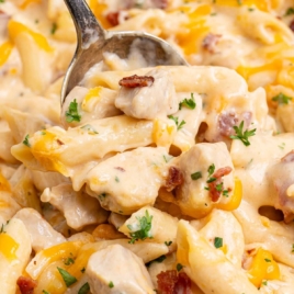 Close-up of crack chicken pasta with penne, chicken, bacon, and cheddar topped with parsley.