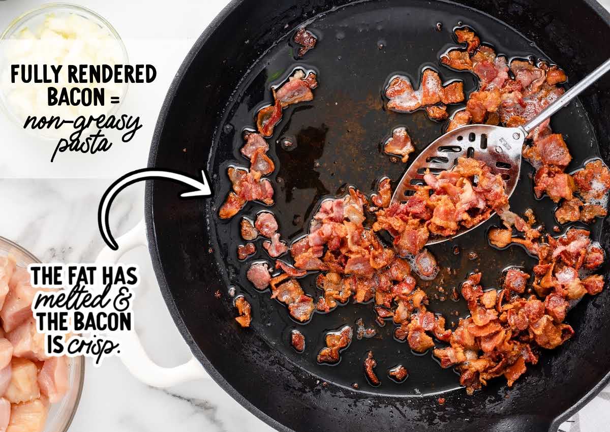 Crispy fully rendered bacon cooking in a skillet with melted fat, showing browned bacon pieces for crack chicken penne.