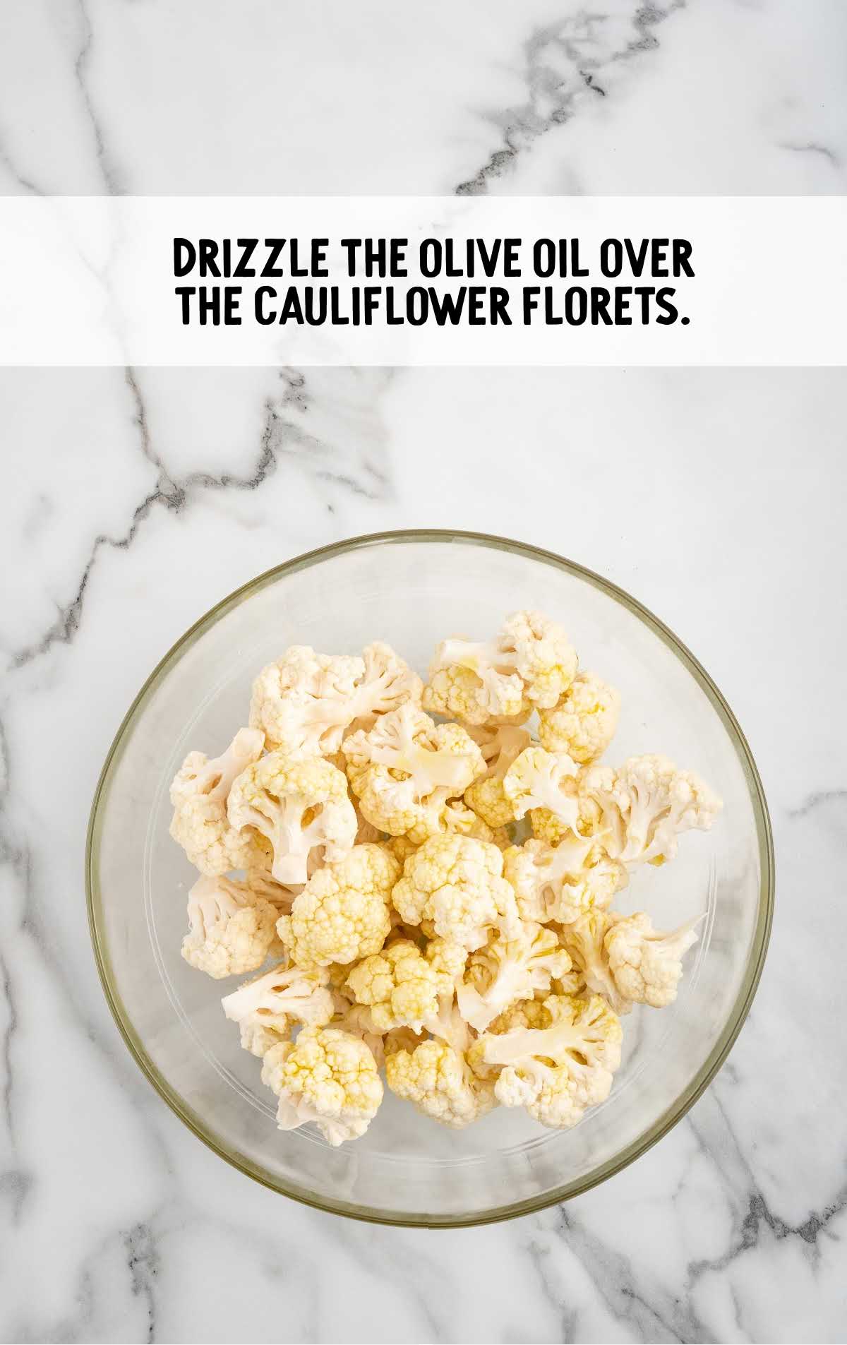 oil drizzled over the cauliflower in a bowl
