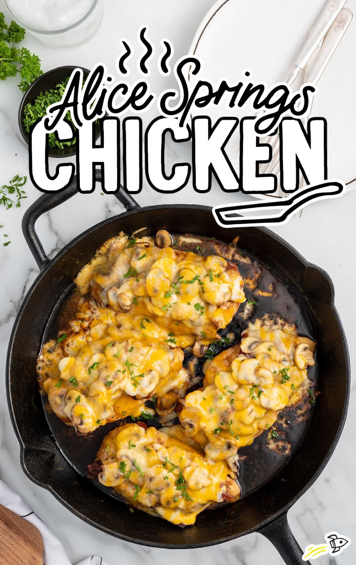 a skillet of chicken garnished with parsley