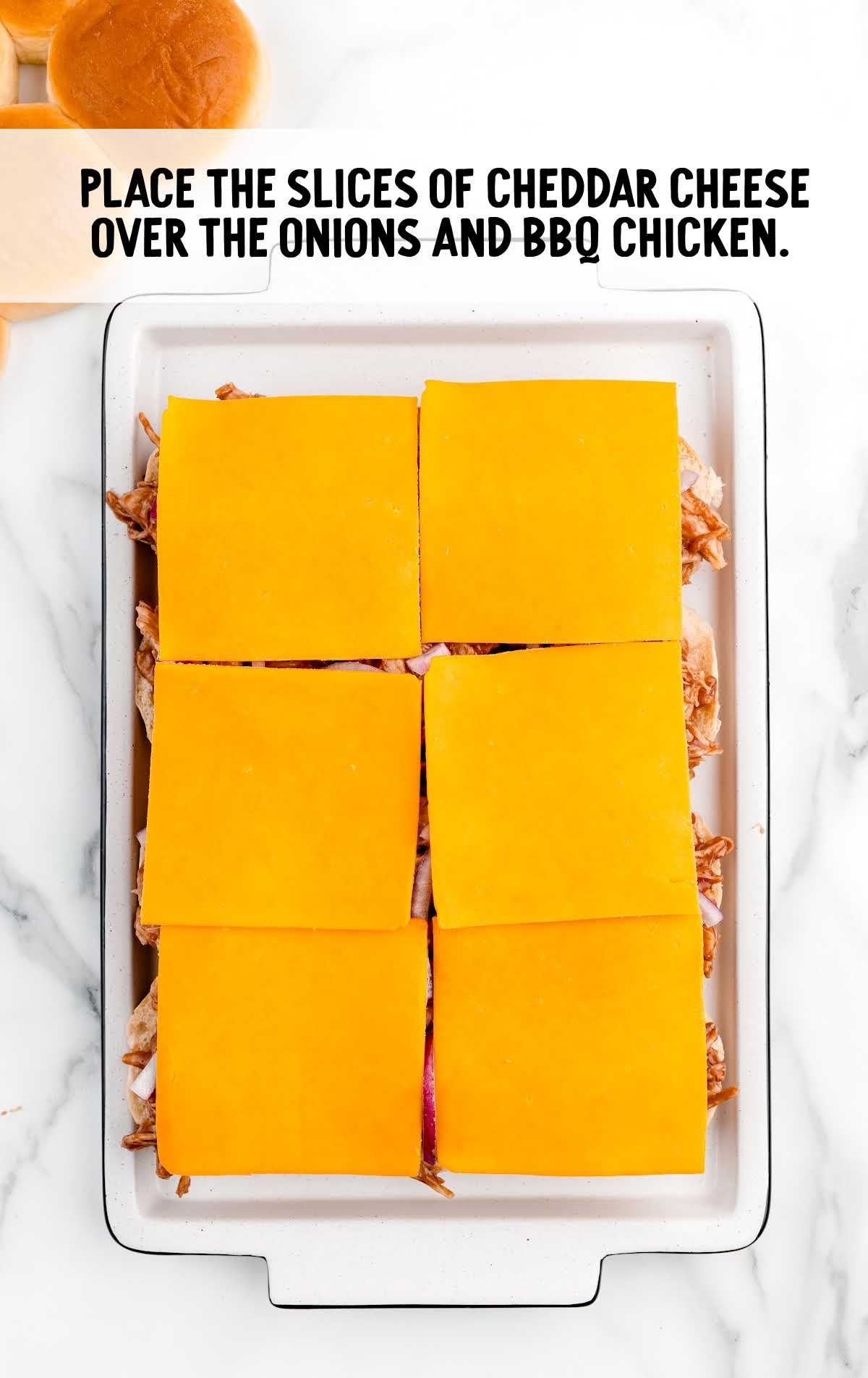slices of cheddar cheese place on top in the baking dish