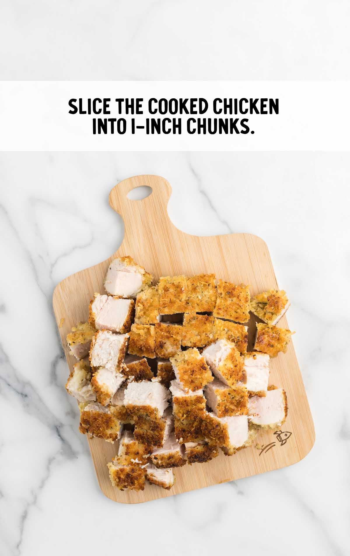chicken sliced into 1 inch chunks on a wooden board