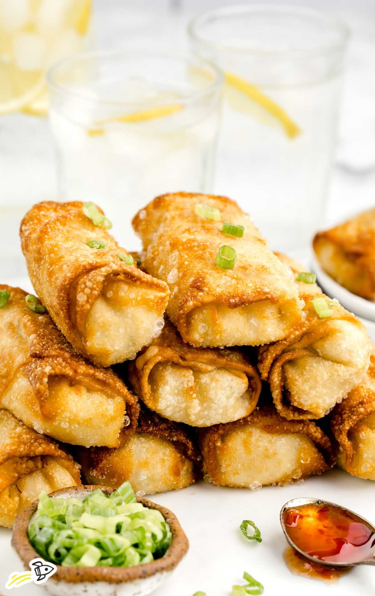 close up shot of Crab Rangoon Eggrolls stacked on top of each other on a plate