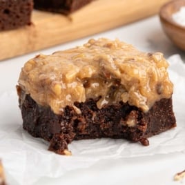 Fudgy German chocolate brownie with a bite taken out, topped with gooey coconut pecan frosting.