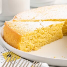 a Italian Lemon Cake topped with powdered sugar on a plate