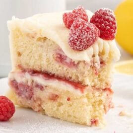 a slice of cake with raspberries on a plate