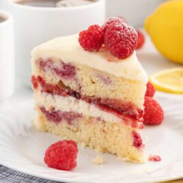 a slice of cake with raspberries on a plate