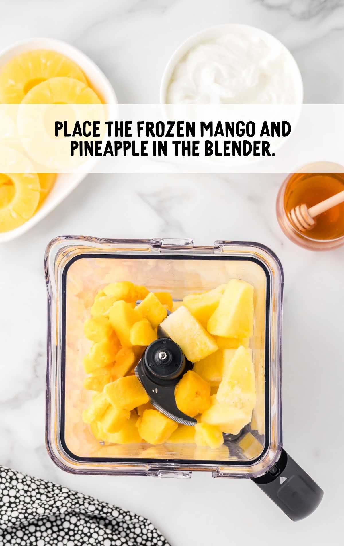mango and pineapple placed in a blended