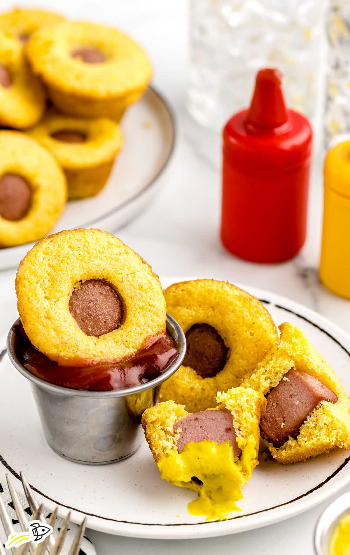 close up shot of Mini Corn Dogs on a plate with a bowl of ketchup