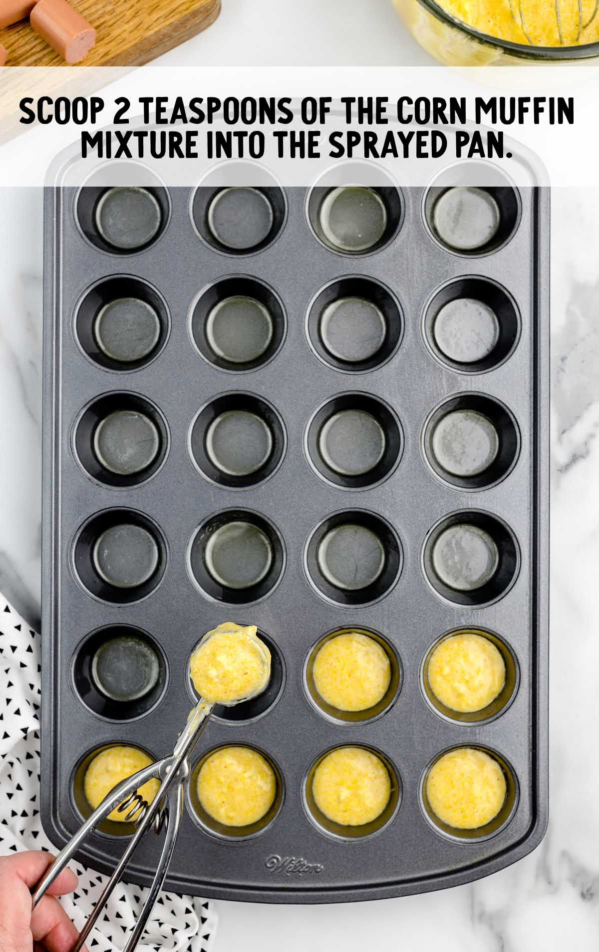 corn muffin mixture placed into the muffin pan