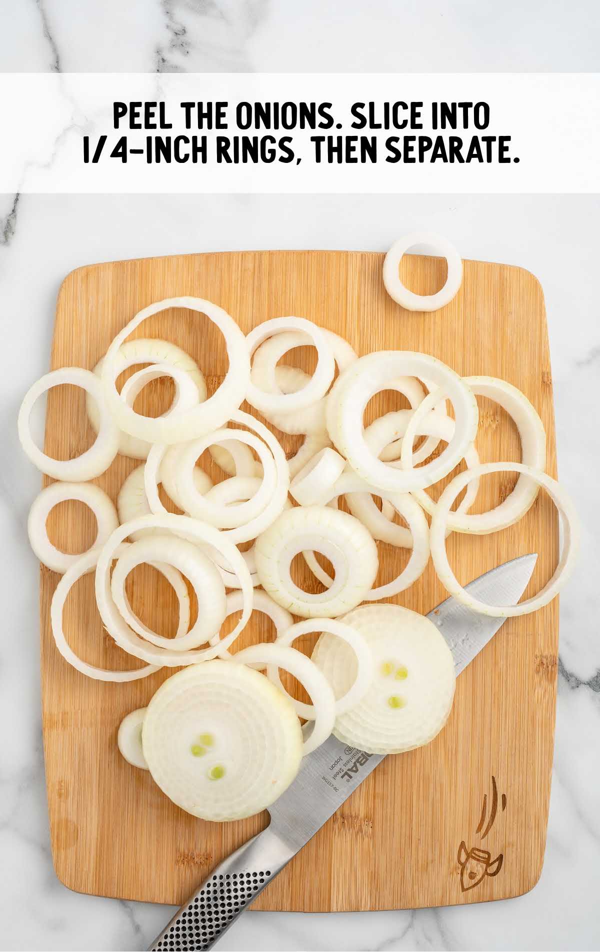 Sliced onion rings on a cutting board with a knife, ready to be separated