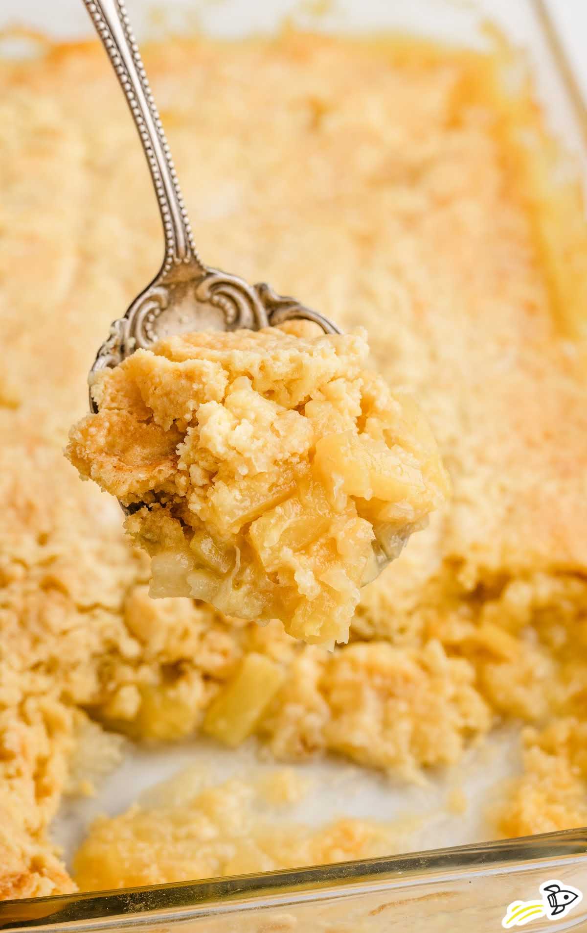 close up shot of a spoon with a piece of Pineapple Dump Cake