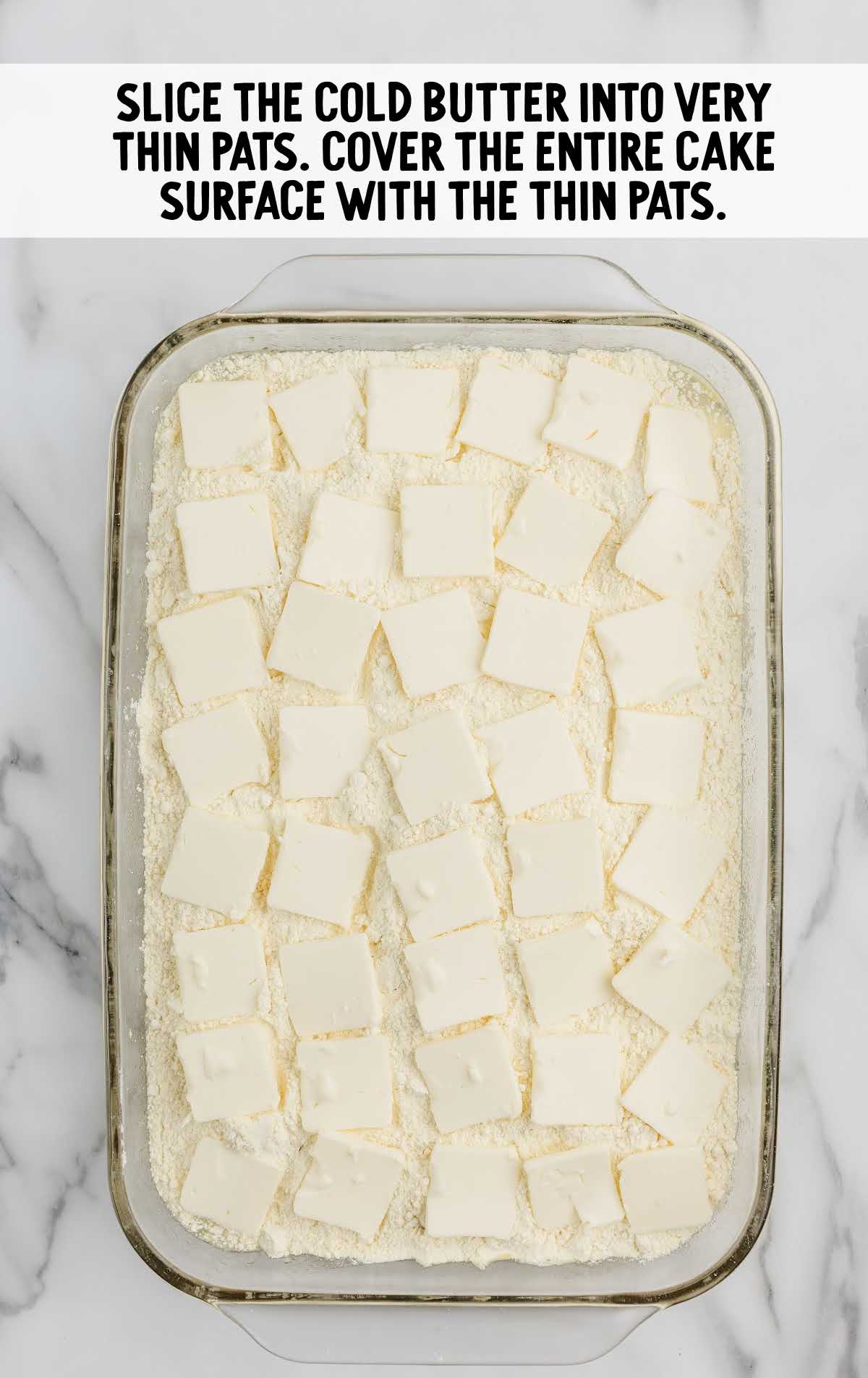 thin sliced butter pats placed on top of the cake