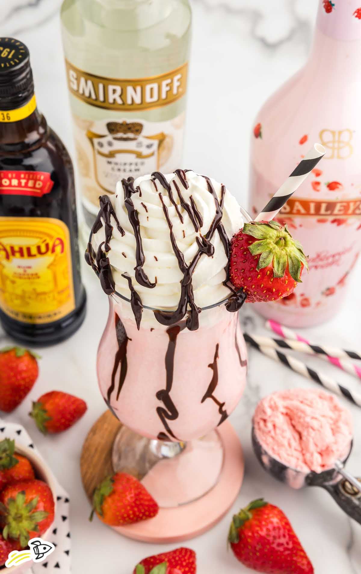 close up shot of a glass of Strawberry Mudslide topped with chocolate sauce, whipped cream, and a strawberry