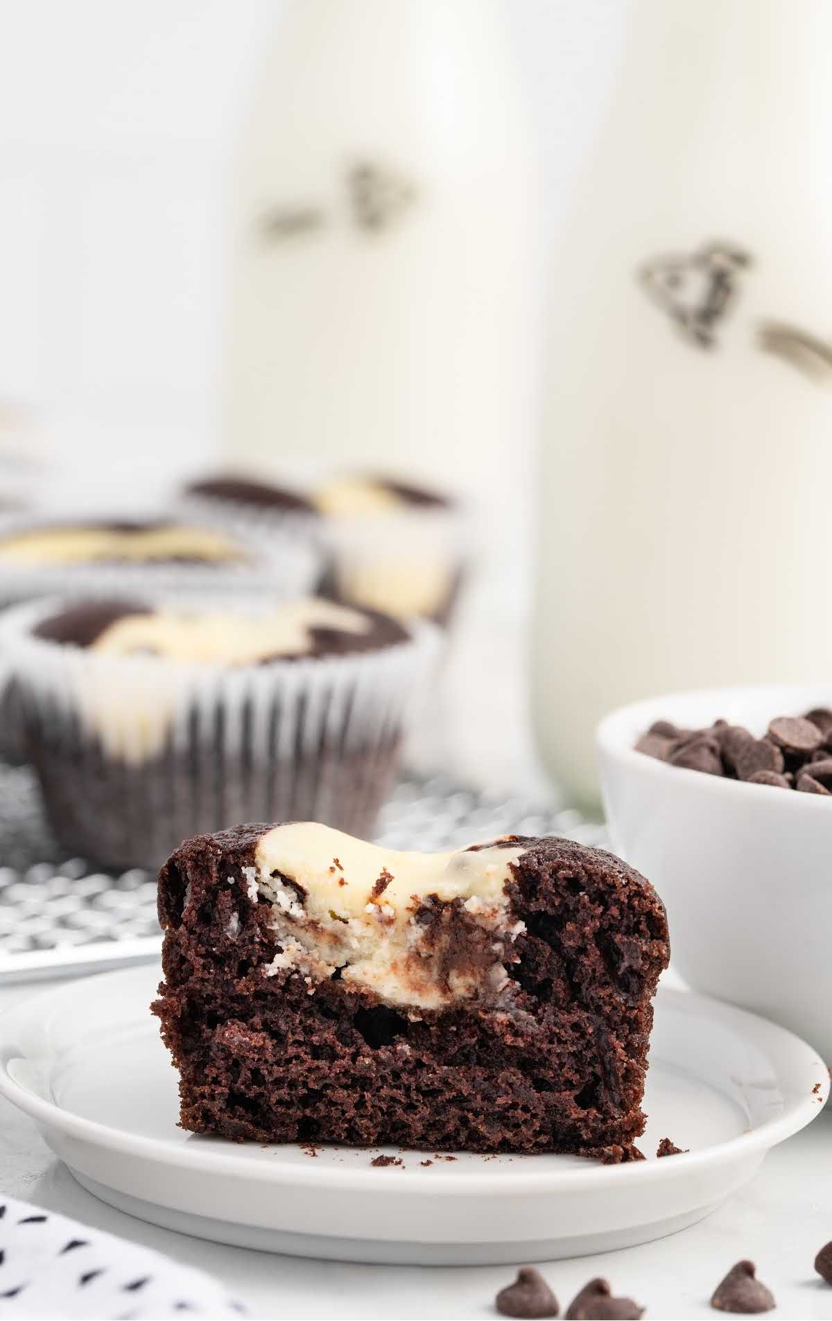 a close up shot of a Black Bottom Cupcake on a plate with a bite taken out of it