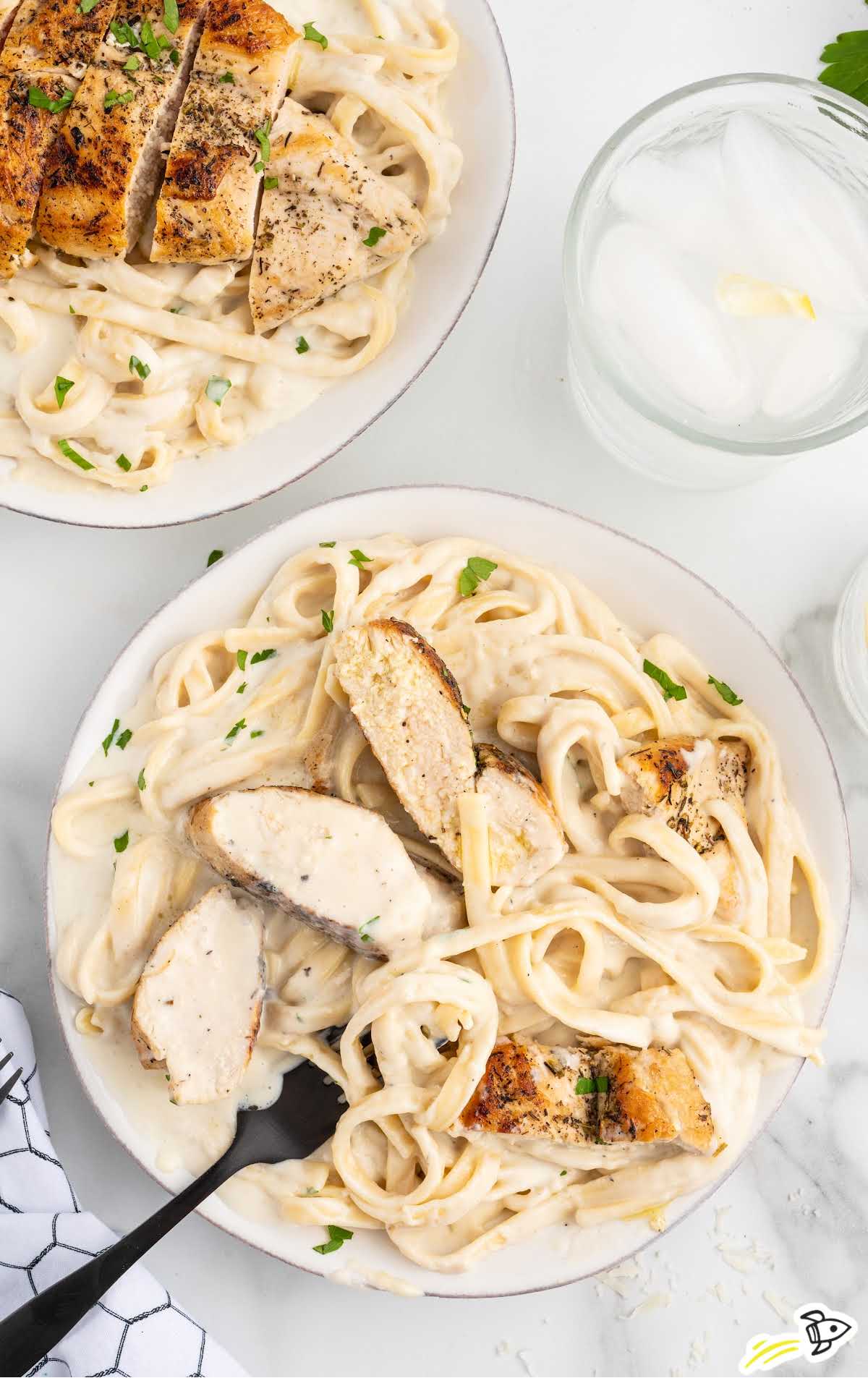 overhead shot of Chicken Alfredo Recipe on a plate with a fork