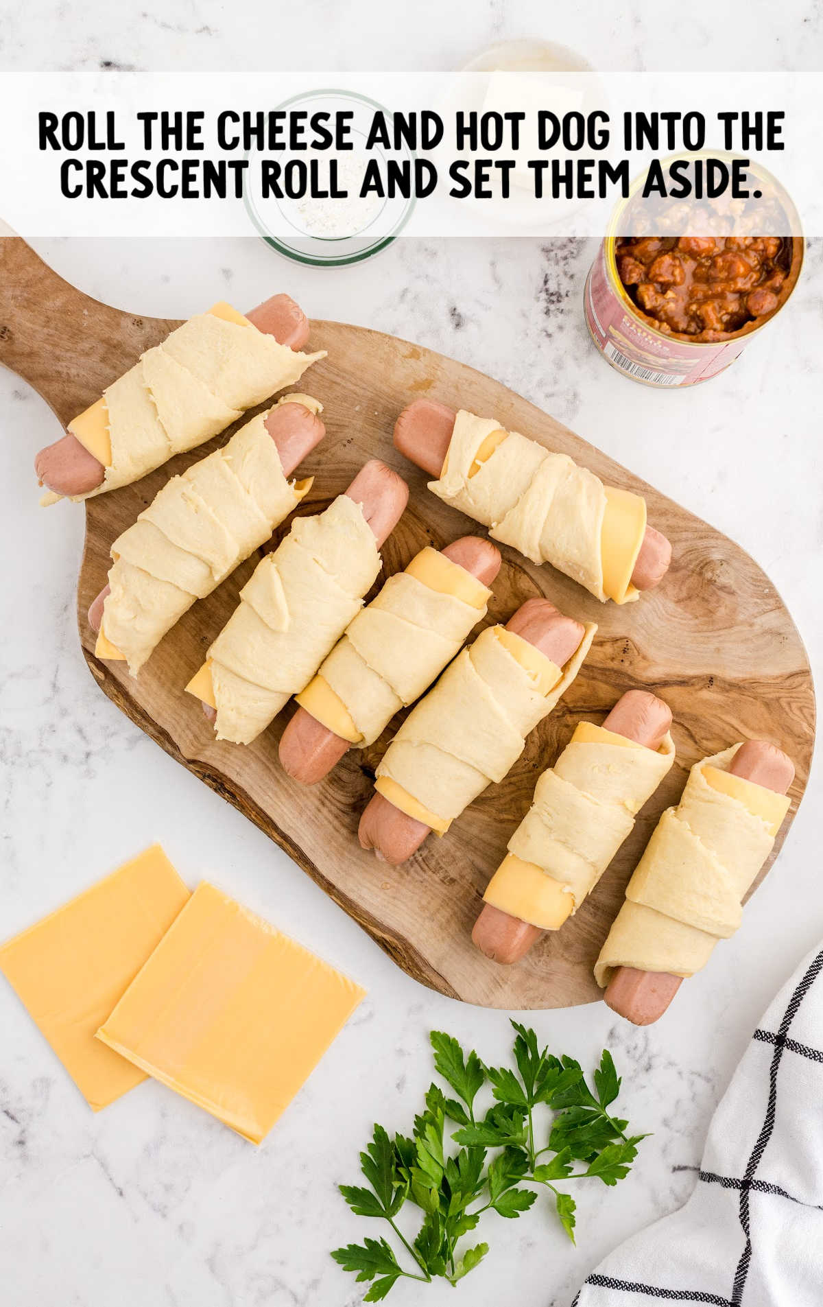 hot dogs rolled up into a slice of cheese and crescent roll