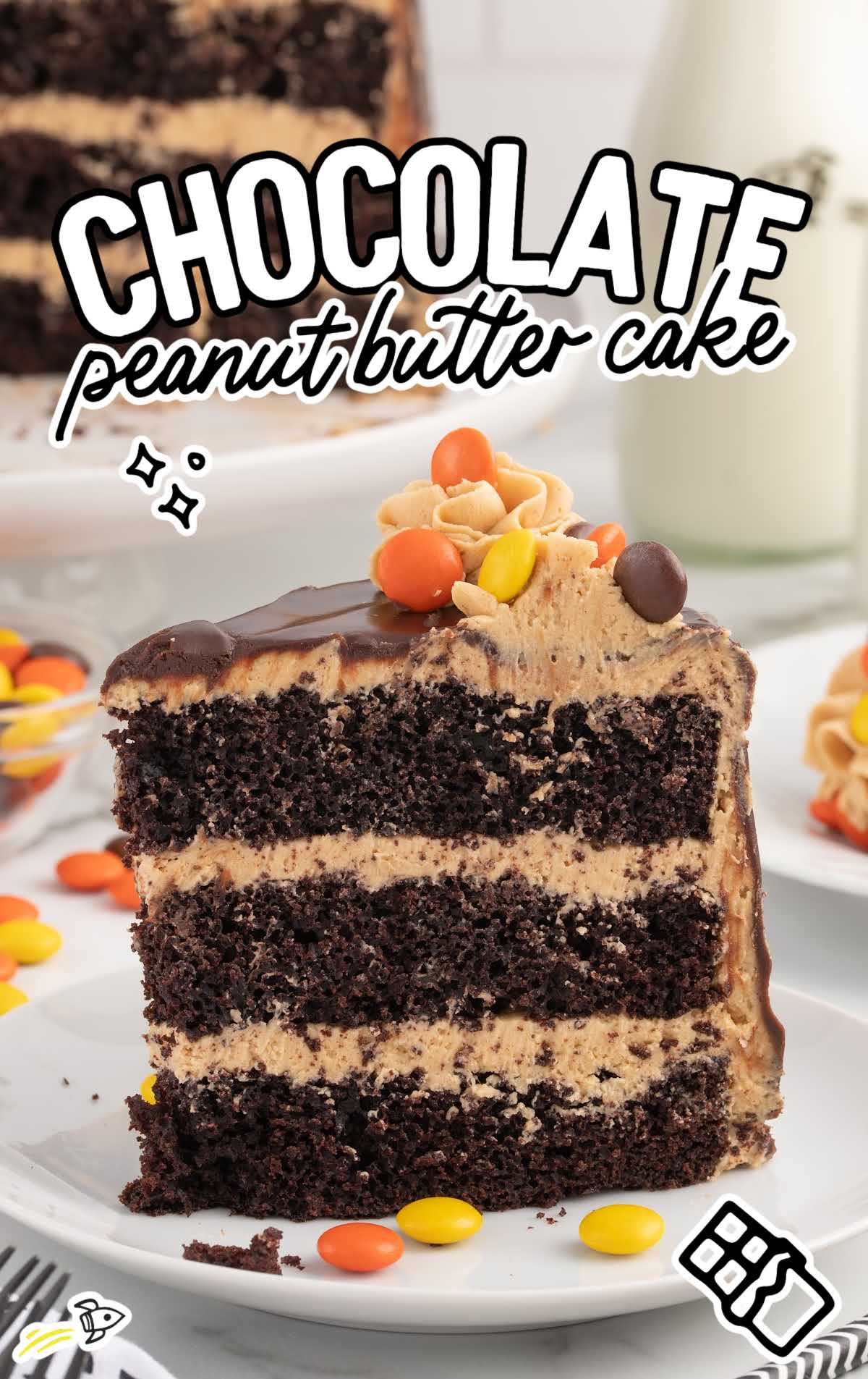 a slice of chocolate cake topped with frosting and Reese's pieces on a plate