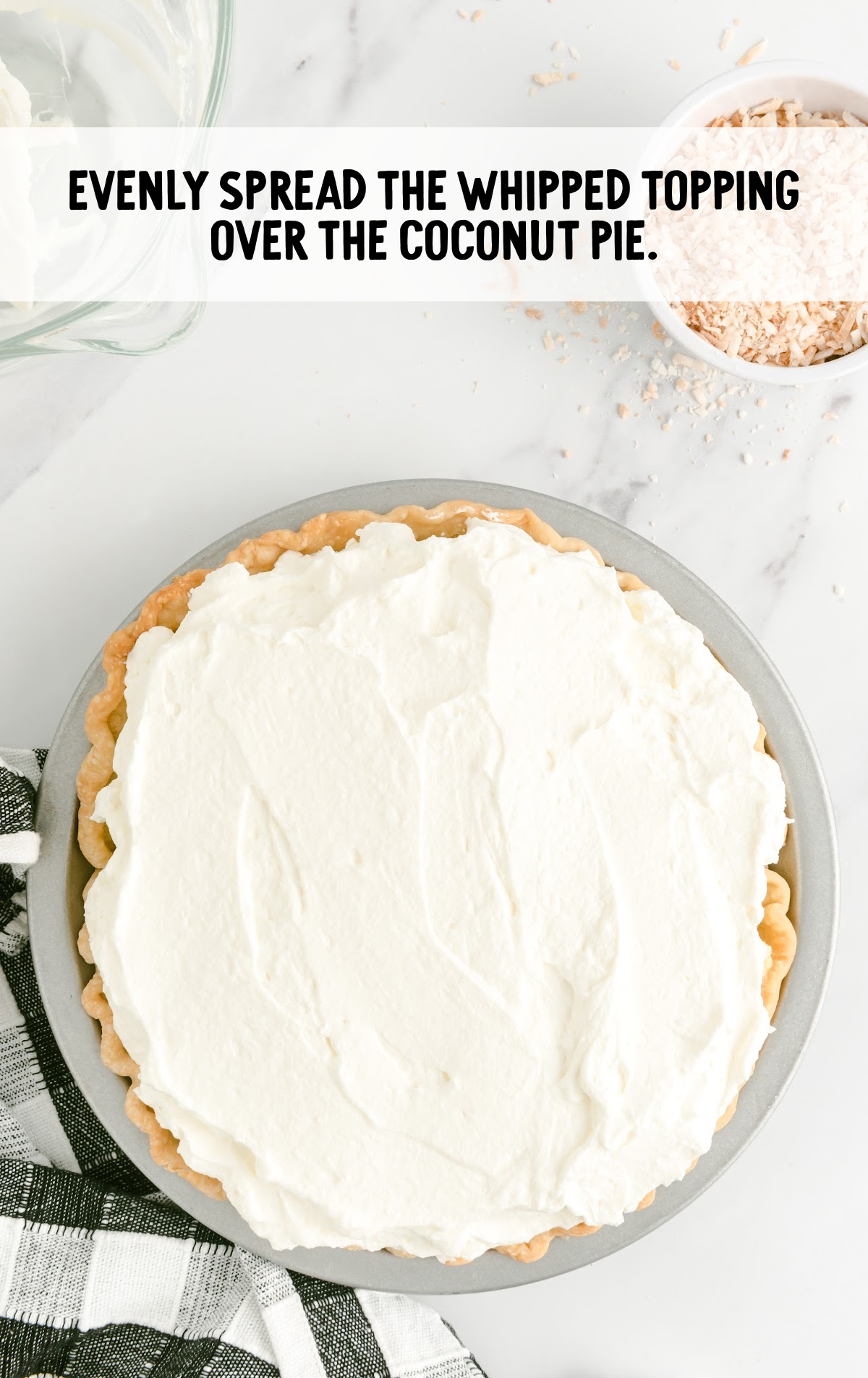 whipped topping spread over the coconut cream pie