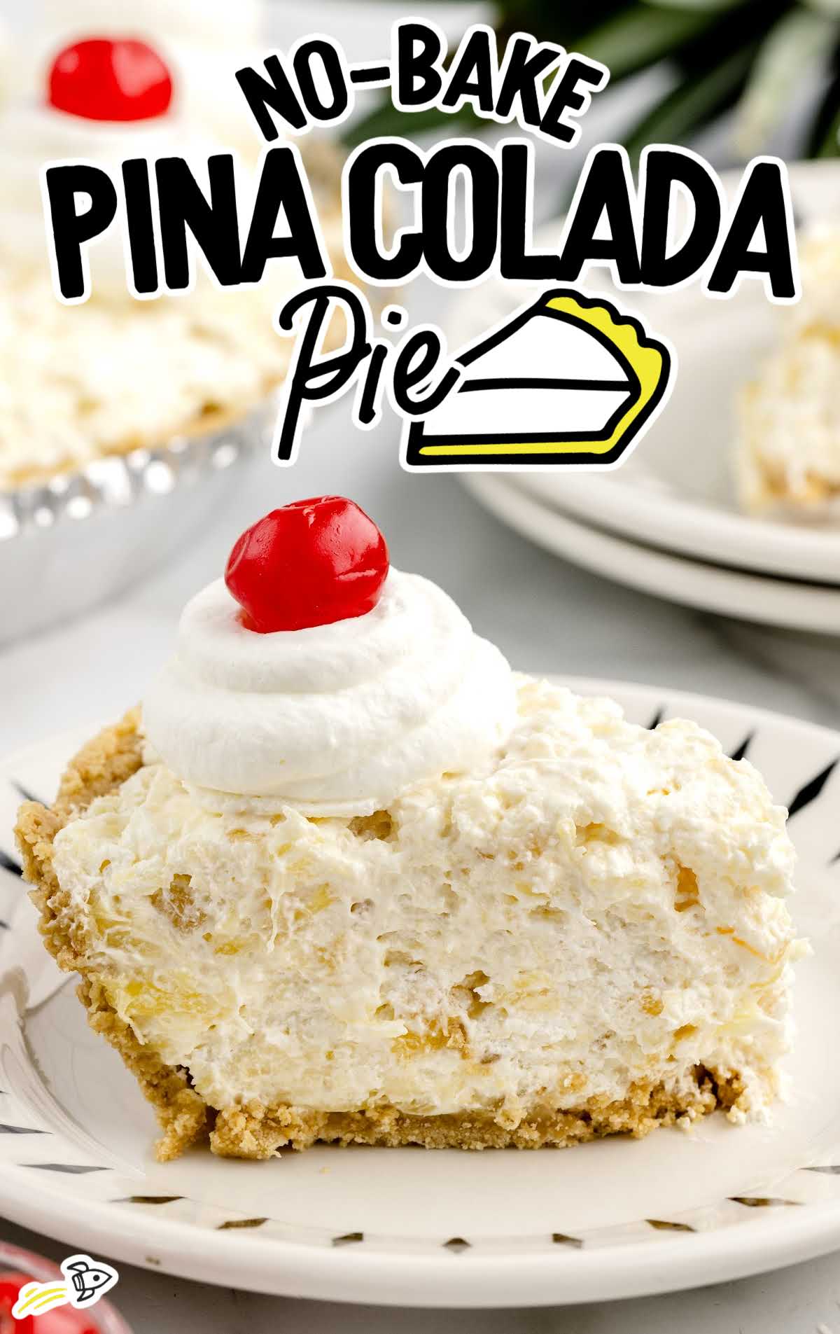 Slice of no-bake piña colada pie with creamy pineapple filling on a graham cracker crust, topped with whipped cream and a maraschino cherry