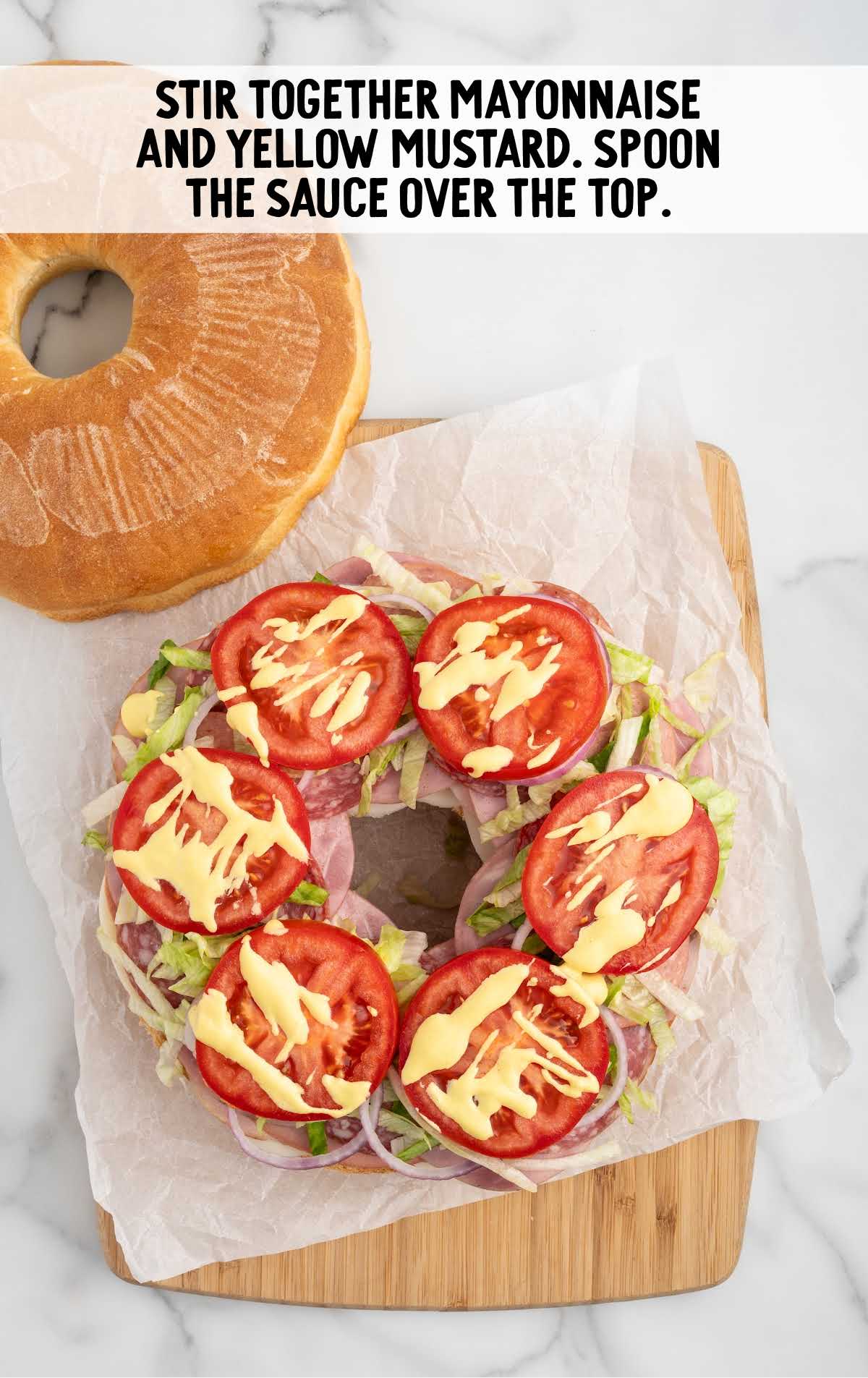 mayo and yellow mustard sauce spooned over the top of the tomato slices