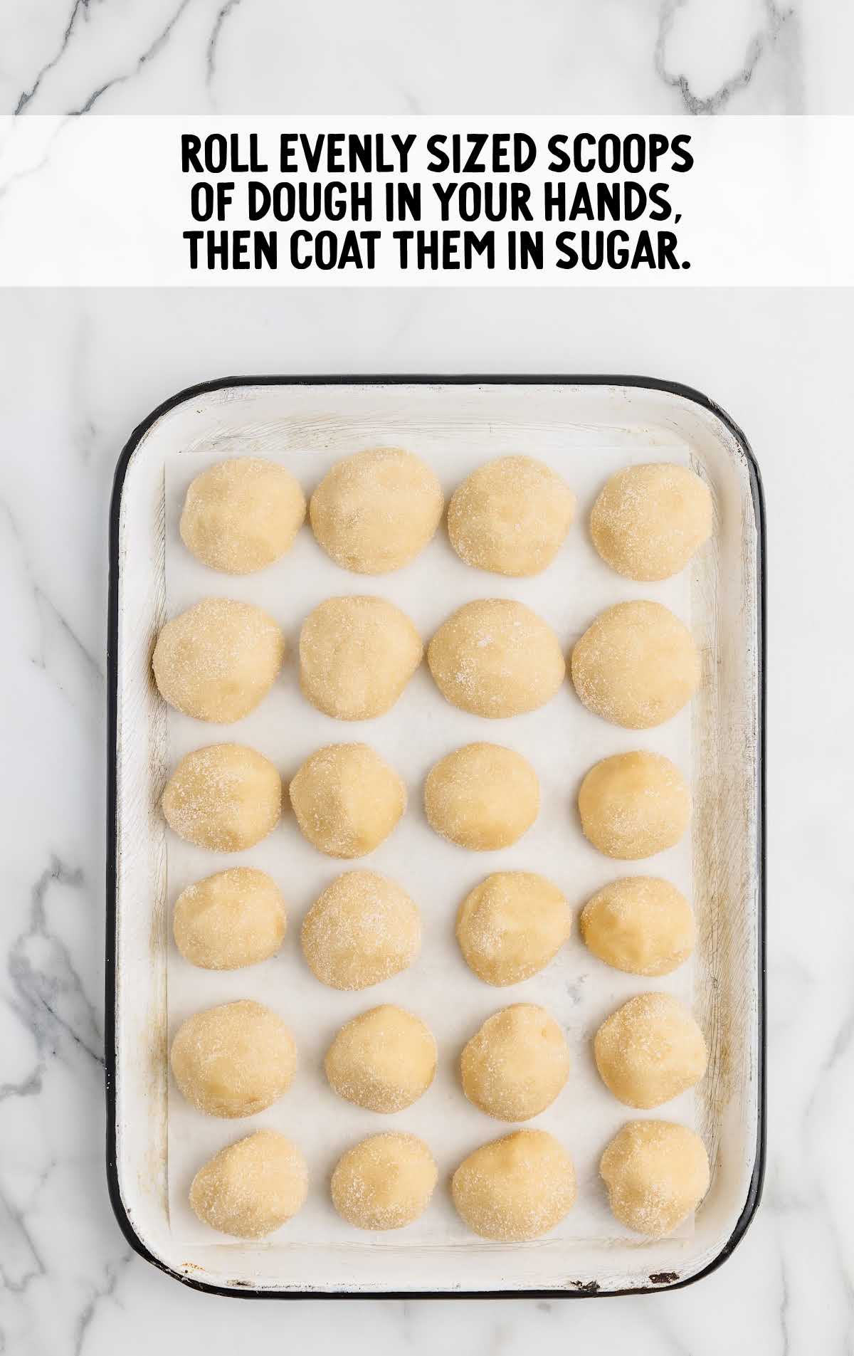 cookie dough rolled into balls on a baking sheet